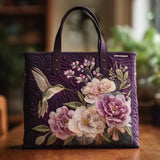 Borsa viola trapuntata con motivo di colibrì e orchidee